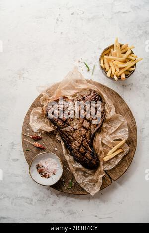 Steak d'os grillé avec frites Banque D'Images