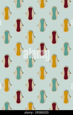 3D motifs de tampons hygiéniques colorés posés à plat sur fond vert Banque D'Images