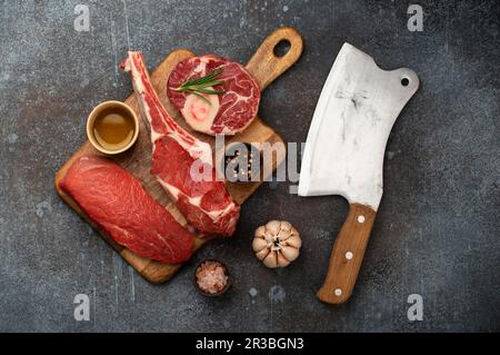 Assortiment de viandes et différents steaks sur bois, cale de viande rustique Banque D'Images