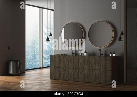 Salle de bains sombre avec parquet, lavabo double, meuble-lavabo en bois, baignoire noire, toilettes noires et miroirs ovales, grande fenêtre. Noir minimaliste Banque D'Images