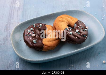 Biscuits sablés végétaliens avec confiture de framboises, trempés dans le glaçage au chocolat et saupoudrées Banque D'Images