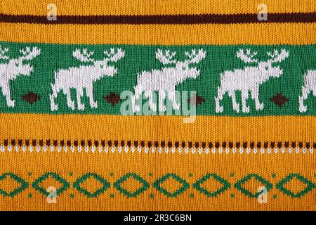 Noël tricot ornemental avec des deers. texture d'arrière-plan du pull tricoté. Tissu tricoté véritable te Banque D'Images