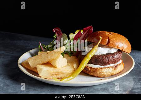 Hamburger au bœuf avec grosses frites et cornichon Banque D'Images