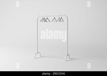 Porte-vêtements blanc avec cintres et ombre moulée sur fond blanc en monochrome à niveaux de gris. Concept de minimalisme, de boutiques et de mode Banque D'Images