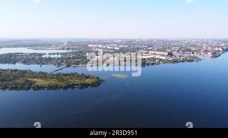 Un drone survole la rivière de l'eau, entourée d'une ville industrielle avec divers bâtiments et Wetland et mar Banque D'Images