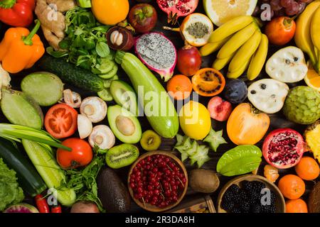 TopView légumes crus, carottes et tométos et carat et gingembre et piment vert et poivron sur une table en bois Banque D'Images