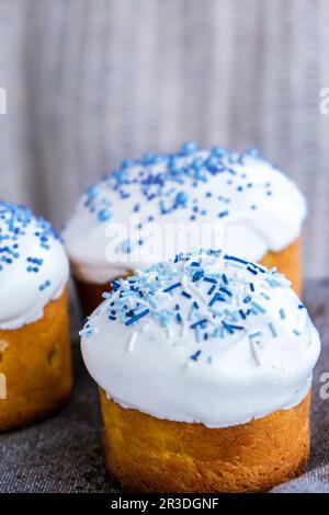 Mains tenir le gâteau de Pâques avec garniture blanche et saupoudrer bleu. Femme tenant un gâteau de Pâques russe traditionnel. Tarte maison pour sp Banque D'Images