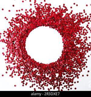 Confettis rouges à cercles scintillants isolés sur blanc. Le cadre idéal pour votre conception. Toile de fond festive pour votre design. Banque D'Images