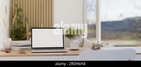 Espace de travail minimaliste avec ordinateur portable maquette d'écran blanc, livres, tasse de café et vase de fleur sur une table en bois sur fond flou d'un minima Banque D'Images