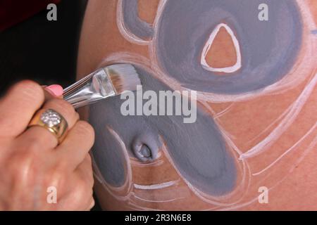 peinture à la main du ventre enceinte. Douche bébé et peinture de chambre Banque D'Images