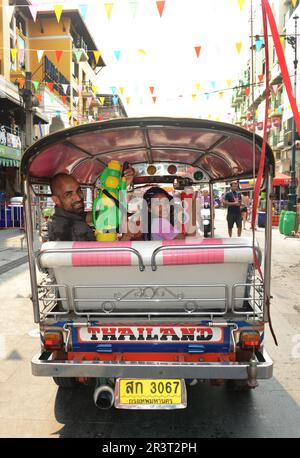 Père et fille tenant des armes à feu dans un Tuktuk pendant le festival Songkran sur Khaosan Road, Bangkok, Thaïlande. Banque D'Images