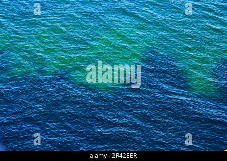 Eaux bleu profond avec des ondulations sur la surface avec des eaux turquoise et bleu clair Banque D'Images