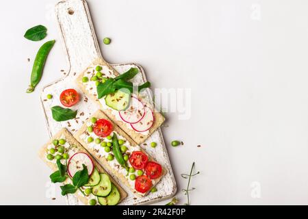 Des sandwiches sains avec du fromage doux et des légumes crus sur du pain croustillant Banque D'Images