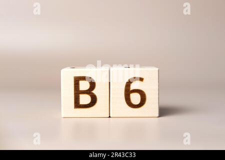 Le mot B6 sur des cubes en bois sur un fond beige neutre studio. Copier l'espace. Écrit. Les mots de texte ont leur importance. Suppléments pour la santé humaine. Pyridoxine. Es Banque D'Images