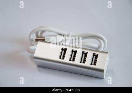 Concentrateur USB à 4 ports, argenté, placé sur un fond blanc Banque D'Images