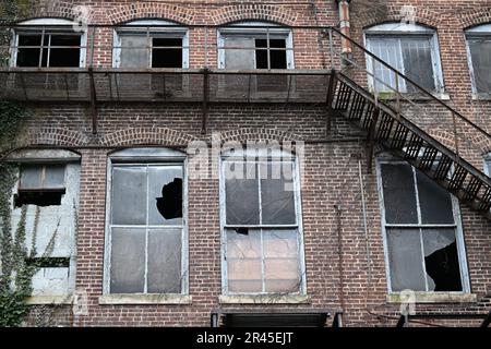 Un extérieur d'un ancien bâtiment dans une zone urbaine avec des fenêtres voûtées Banque D'Images