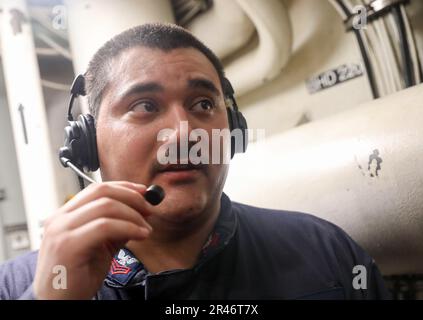 MER DE CHINE DU SUD (29 mars 2023) – technicien de Hull 1st classe Raul Perez, de Visalia, Californie, communique avec la station de contrôle centrale lors d'un exercice d'entraînement technique à bord du destroyer de missile guidé de classe Arleigh Burke USS Milius (DDG 69) lors d'une opération en mer de Chine du Sud, au 29 mars. Milius est affecté au commandant de la Force opérationnelle 71/Escadrier Squadron (DESRON) 15, la plus grande force de surface déployée à l’avant de la Marine et la principale force de surface de la flotte américaine 7th. Banque D'Images