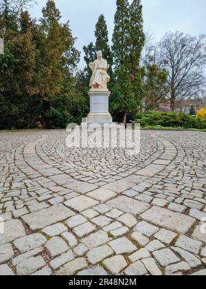 Statue en marbre du poète et écrivain autrichien Robert Hamerling assis dans une chaise dans le parc de la ville Stadtpark, à Graz, région de Steiermark, Autriche. Sél Banque D'Images