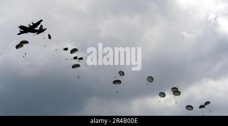 US NAVY A U.S. Le Hercules C-130E de la Force aérienne dépose un gros bâton de parachutistes affectés aux États-Unis Armée 82nd Airborne, devant la foule à la base aérienne Andrews, au Maryland, pendant l'ouverture du Service interarmées de 2005. Banque D'Images