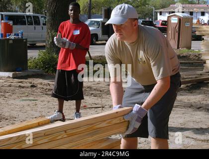 LE chef DE L'ÉLECTRONIQUE DE l'AVIATION DE LA MARINE AMÉRICAINE dresse une pile de bois d'œuvre lors d'un projet Habitat for Humanity local aux McNair Park Villas dans le centre-ville de Jacksonville. Banque D'Images