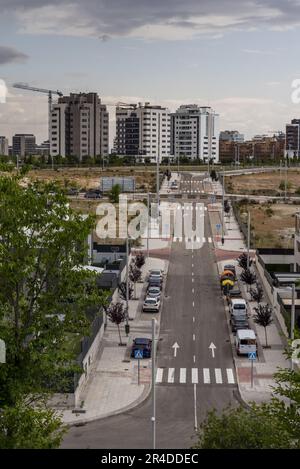 Une longue rue semi vide dans un nouveau quartier en construction à la périphérie de la ville de Madrid Banque D'Images