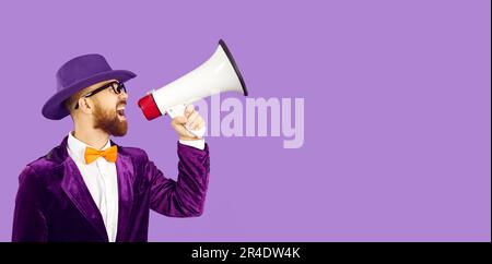 Un homme excentrique en velours violet se crie dans le mégaphone isolé sur fond violet. Banque D'Images