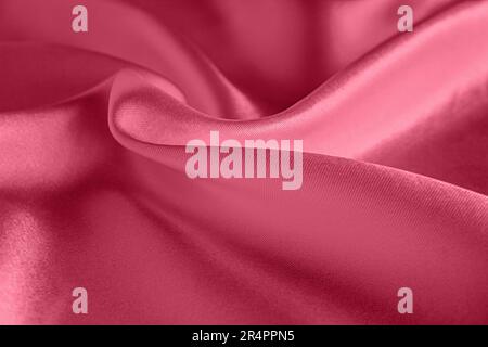 Texture d'arrière-plan en soie Viva Magenta, motif abstrait pour le design. Échantillon de la couleur de l'année 2023. Banque D'Images