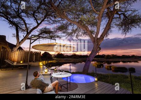 Vue sur le coucher du soleil depuis une suite de luxe à Onguma Camp Kala - Onguma Game Reserve, Namibie, Afrique Banque D'Images