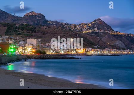 Vue sur Taormina et la promenade de Giardini Naxos vue depuis Giardini Naxos au crépuscule, Sicile, Méditerranée, Italie, Europe Banque D'Images