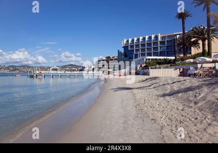 France, Provence-Alpes-Côte d'Azur, Antibes Juan-les-Pins, plage avec touristes bronzer et nager dans la mer. Banque D'Images