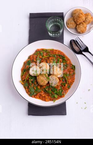 Lentilles rouges aux épinards et aux boulettes de riz frites Banque D'Images