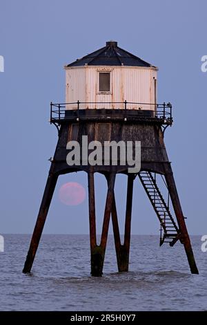 Dovercourt Essex, Royaume-Uni. 3rd juin 2023. La Strawberry Moon s'élève derrière le phare inférieur de Dovercourt dans l'Essex. La pleine Lune de juin est appelée la Lune des fraises, non pas à cause de sa couleur, mais parce que les tribus algonquines d'Amérique du Nord l'ont nommée en raison de sa présence pendant la saison de récolte des fraises. Crédit : MARTIN DALTON/Alay Live News Banque D'Images