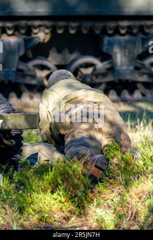 Reconstruction historique. Un soldat d'infanterie américain de la seconde Guerre mondiale combattant dans la forêt. Vue de l'arrière. Banque D'Images