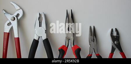 Top parts of variety types of pliers lined up in size comparison Stock Photo