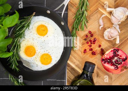Gros plan d'une casserole d'œufs brouillés et de légumes, garnie d'herbes aromatiques Banque D'Images
