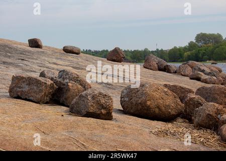 La côte du golfe de Finlande. Sur la roche se trouvent de grandes pierres de granit-blocs. La nature dure du Nord. Banque D'Images