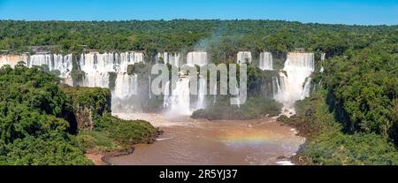 Vue panoramique de la cascade spectaculaire des chutes d'Iguazu au soleil et rivière brune, Argentine Banque D'Images