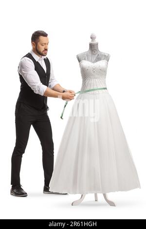 Sur mesure prendre des mesures pour une robe de mariée sur une poupée de mannequin isolée sur fond blanc Banque D'Images