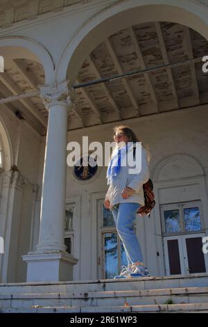 La photo a été prise dans la ville d'Odessa en Ukraine. Une jeune touriste sur les escaliers d'un ancien domaine situé sur le boulevard français dans l'ancien d Banque D'Images