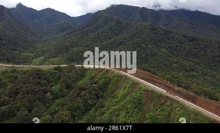 Une vue panoramique d'une autoroute vide serpentant à travers un paysage de montagne Banque D'Images