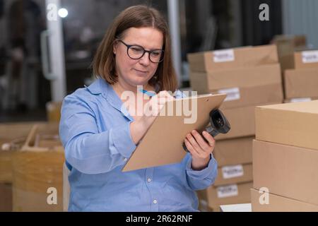 propriétaire d'une petite entreprise de la boutique en ligne, vérifie le suivi des commandes de gestion des expéditions de produits et de l'emballage Banque D'Images