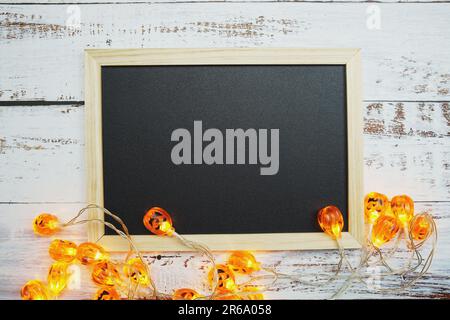 Lumières à DEL de citrouille pour Halloween décorations sur fond en bois Banque D'Images