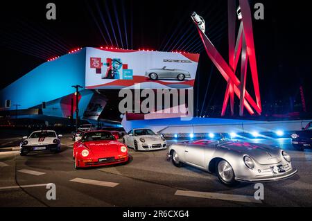 Stuttgart, Allemagne. 08th juin 2023. Divers véhicules Porsche sont garés sur la Porscheplatz illuminée de couleurs lors de l'événement marquant 75 ans de voitures de sport Porsche. Credit: Christoph Schmidt/dpa/Alay Live News Banque D'Images