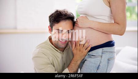 Couple enceinte attendant bébé. Mains sur ventre belly Banque D'Images