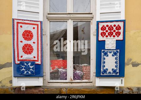 Szentendre, Hongrie - 30 novembre 2022 : objets brodés traditionnels hongrois colorés, dans une fenêtre du village hongrois Szentendre. Banque D'Images