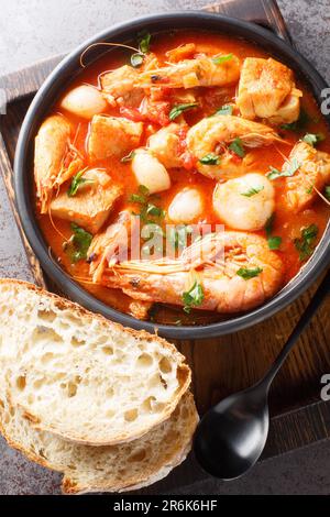 Fruits de mer croates Scouw Brudet avec du poisson, des crevettes, des moules, des pétoncles, des calmars dans un bol sur la table. Vue verticale du dessus Banque D'Images