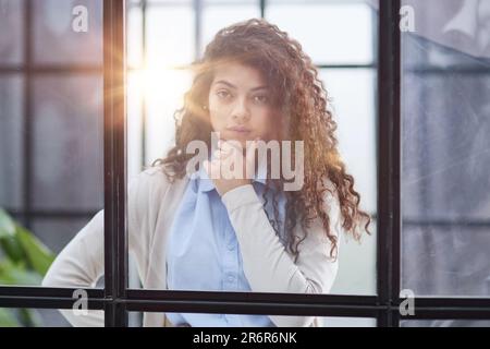 Femme d'affaires dans le bureau à l'extérieur de la fenêtre Banque D'Images