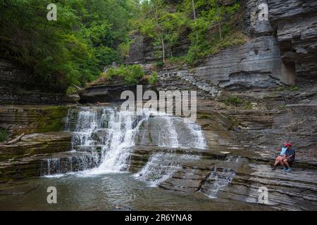 Ithaca, NY, USA - 11 juin 2023 : un couple observe les rapides de Lucifer Falls dans le parc national Robert H. Treman situé dans la région de Finger Lakes de New Banque D'Images