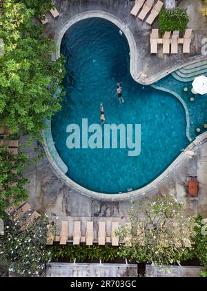 Deux personnes se détendent dans la piscine, Kuta, Bali, Indonésie Banque D'Images