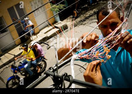 Des travailleurs réparent des lignes électriques à Caracas, au Venezuela. Banque D'Images
